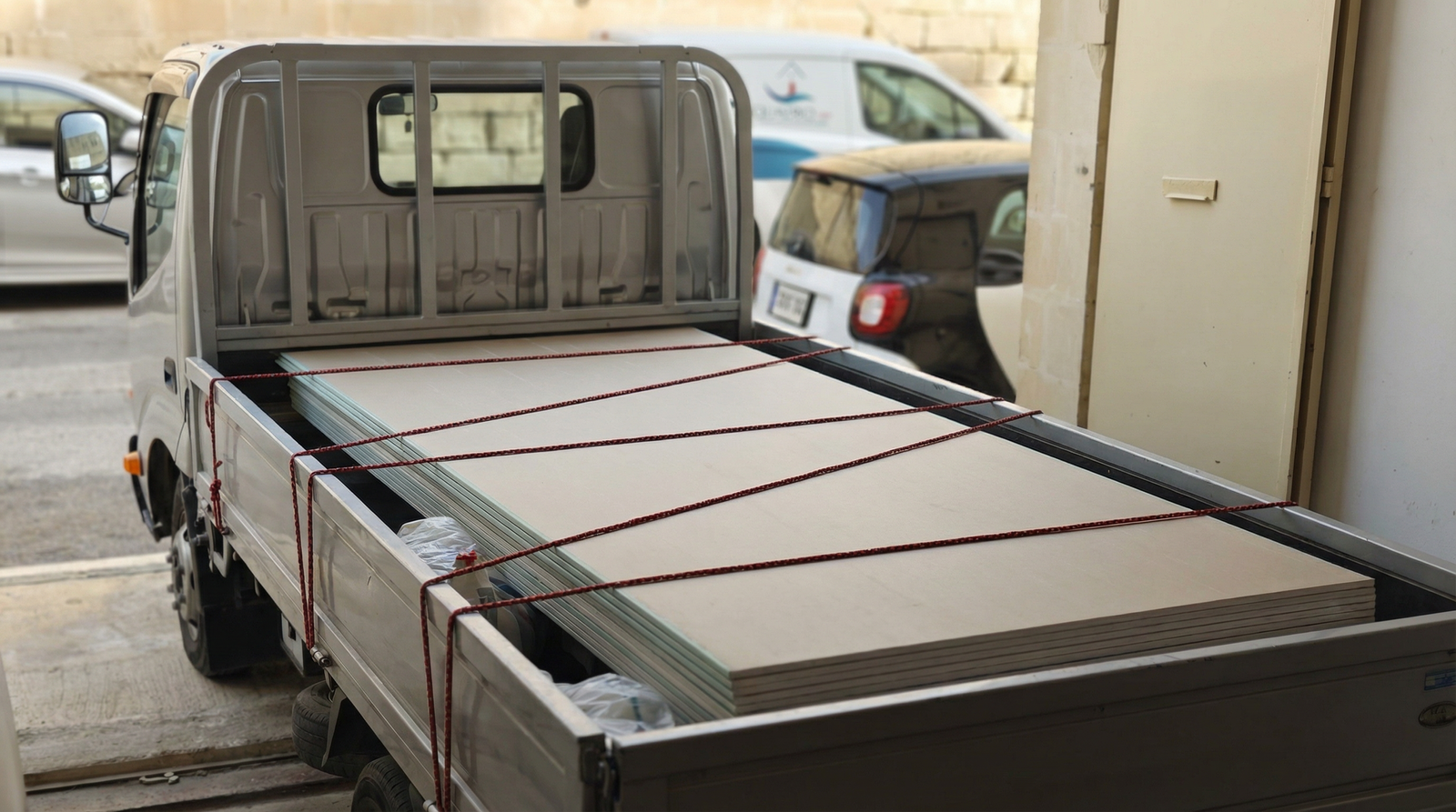 Truck loaded with gypsum boards and metal profiles for delivery